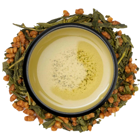 A cup of golden genmaicha seen from above, ringed by green tea leaves and roasted brown rice on a white background